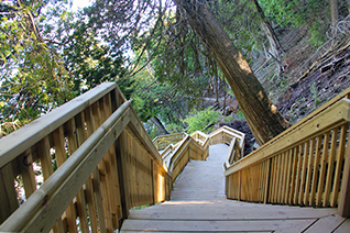 Stairway through the woods from Lake Shore Drive to Arch Rock on Mackinac Island, Michigan.