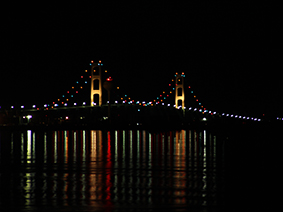 The Mackinac Bridge viewed from Mackinaw City in the Lower Peninsula of Michigan is the longest suspension bridge between anchorages in the Western hemisphere. It crosses the Straights of Mackinac and connects the Upper and Lower Peninsulas of Michigan with Lake Michigan on its west side and Lake Huron on the east.