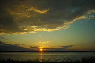 Sunset over Little Traverse Bay viewed from US-31 between Petoskey and Charlevoix, Michigan.