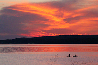 A couple paddles their waterboards into Little Traverse Bay in Petoskey, Michigan.
